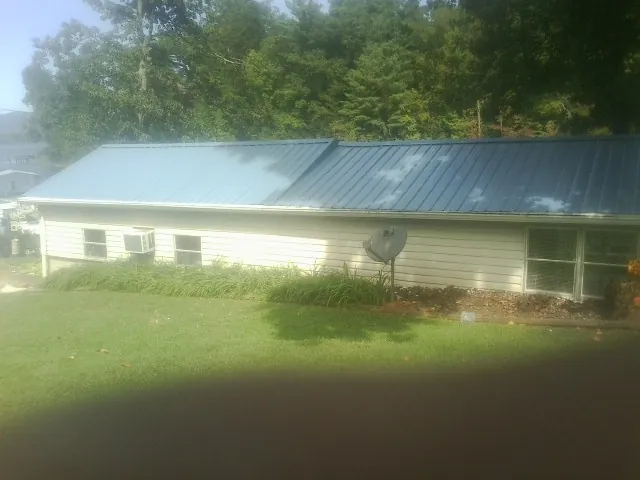 Blue metal roof running the length of a single story home in Clintondale