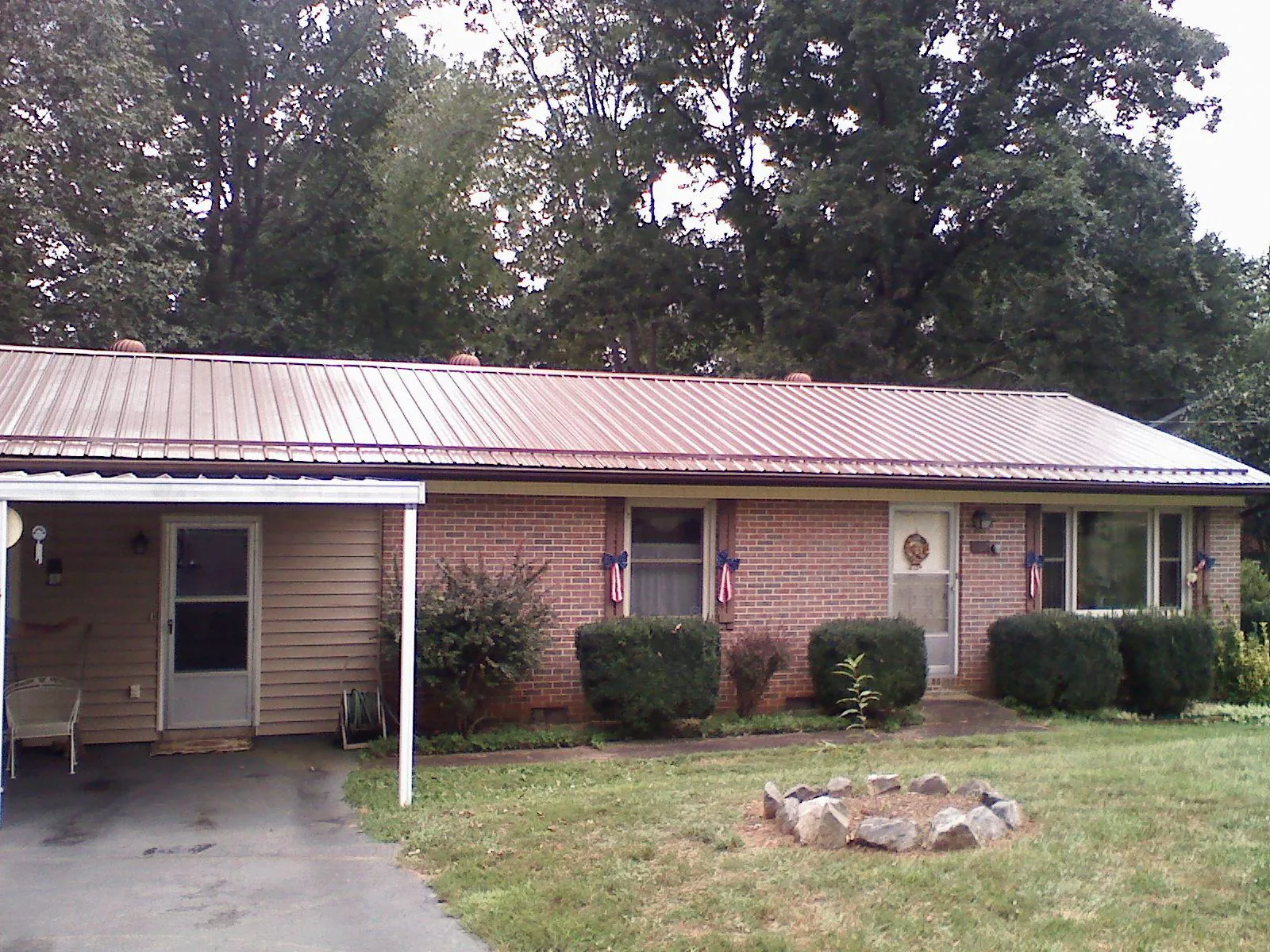 Bronze metal roof and carport on a brick ranch home — Roof Repair work by our crew in Clintondale